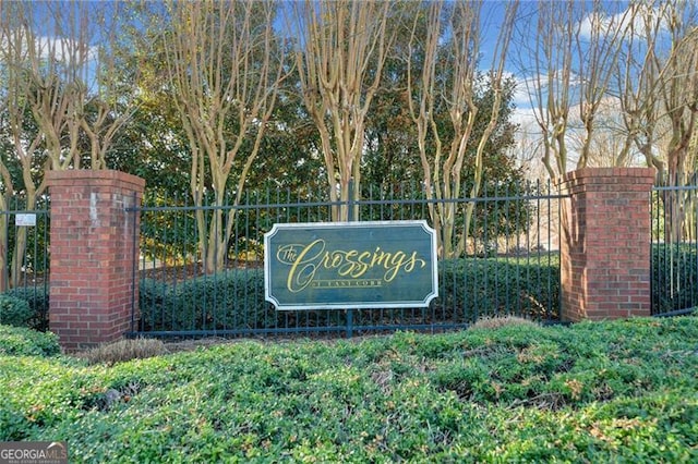 community sign featuring fence