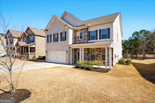 view of front of property with brick siding, concrete driveway, a front yard, a garage, and stone siding