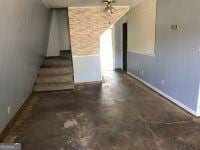 interior space with stairway and concrete flooring