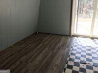 unfurnished room featuring dark wood-style flooring