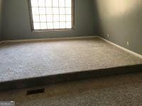 unfurnished room with baseboards and carpet floors