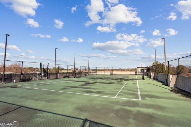 view of sport court featuring fence