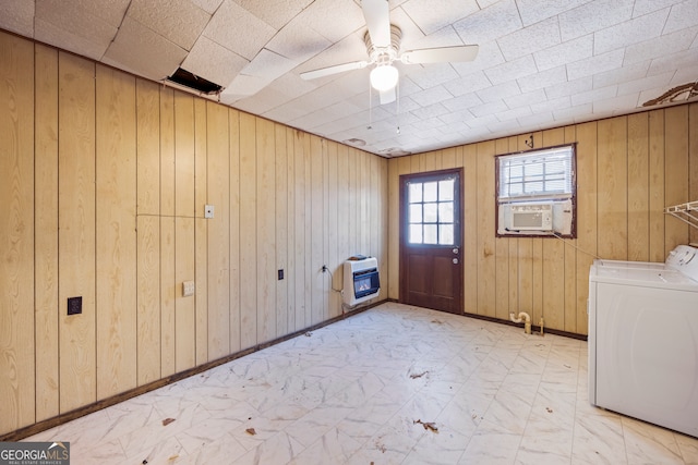 laundry area featuring baseboards, ceiling fan, laundry area, cooling unit, and heating unit