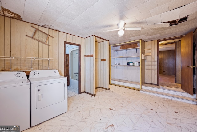 laundry area with marble finish floor, washer and dryer, wooden walls, ceiling fan, and laundry area