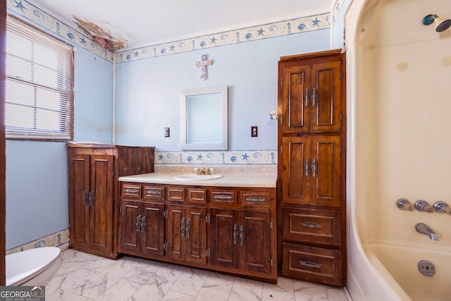 bathroom featuring marble finish floor, toilet, and vanity