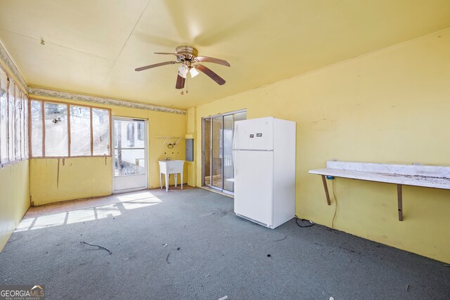 interior space featuring a sink, carpet floors, electric panel, and ceiling fan