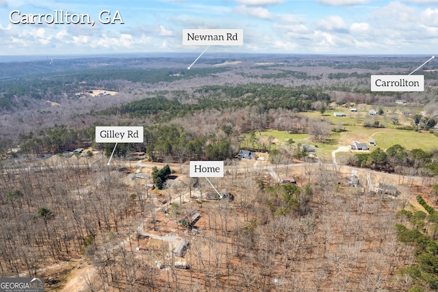 birds eye view of property featuring a view of trees