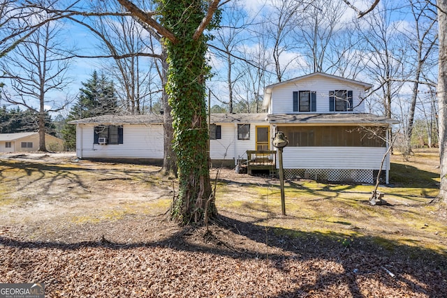 back of property with a sunroom