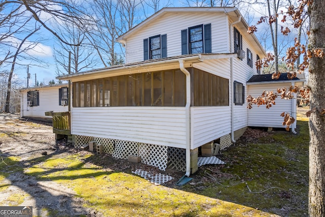 view of home's exterior with a sunroom