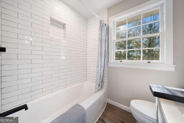 full bathroom with toilet, shower / bath combo with shower curtain, baseboards, and wood finished floors