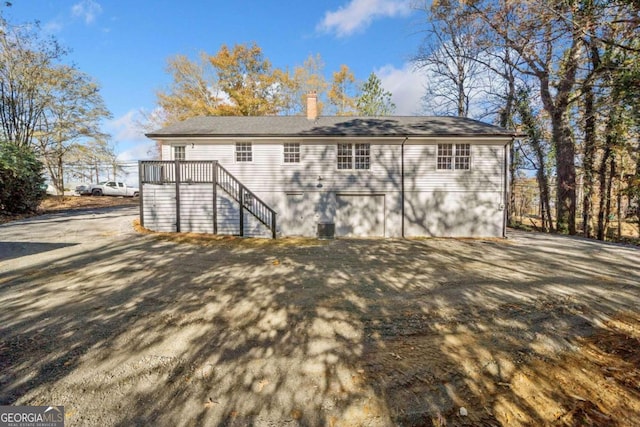 back of property featuring stairway and a chimney