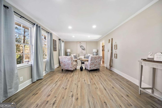 sitting room featuring recessed lighting, wood finished floors, baseboards, and ornamental molding