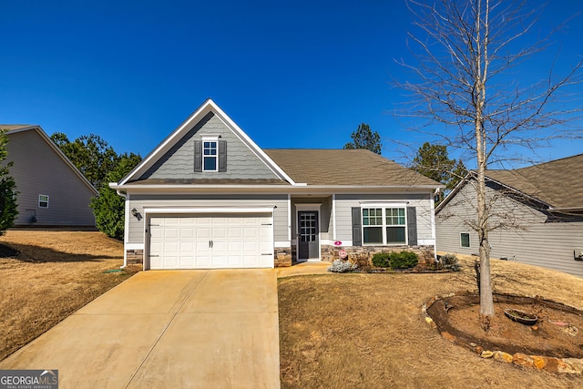 craftsman inspired home with a garage, stone siding, and concrete driveway