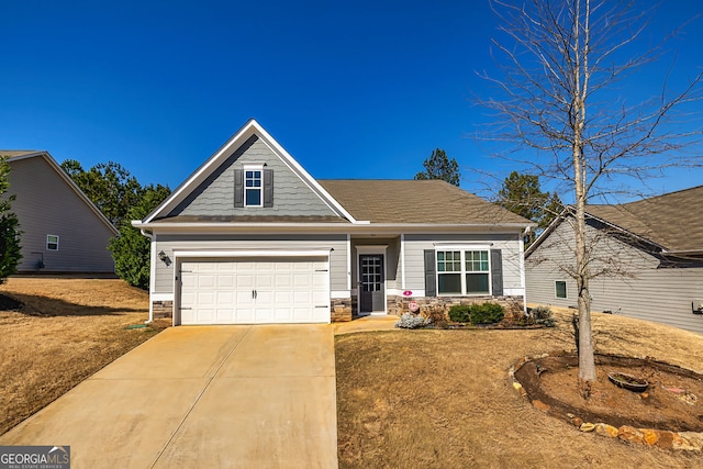 4 October Ave, Newnan, GA 30265 - view of front of house with driveway, a front yard, stone siding, and a garage