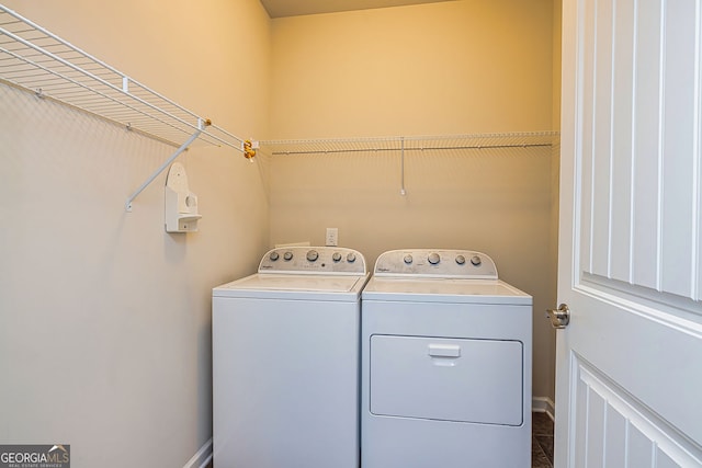 clothes washing area featuring washer and dryer and laundry area