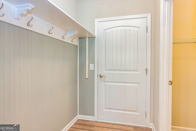 mudroom featuring wood finished floors and baseboards