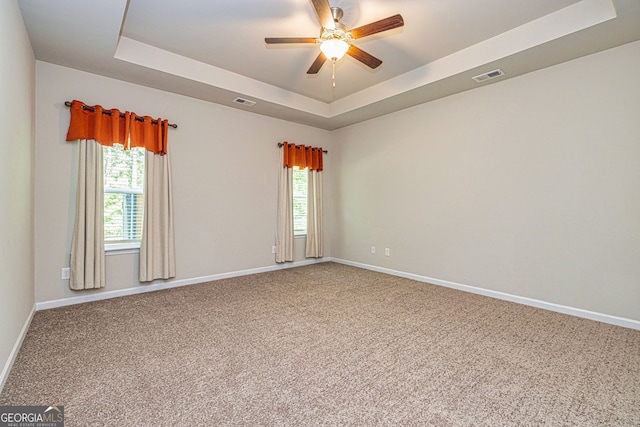 4 October Ave, Newnan, GA 30265 - carpeted empty room with a raised ceiling, a ceiling fan, and plenty of natural light