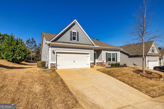 view of front of house with stone siding, concrete driveway, and an attached garage