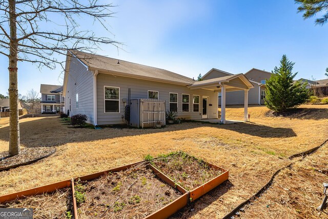 4 October Ave, Newnan, GA 30265 - back of house with a vegetable garden and a yard