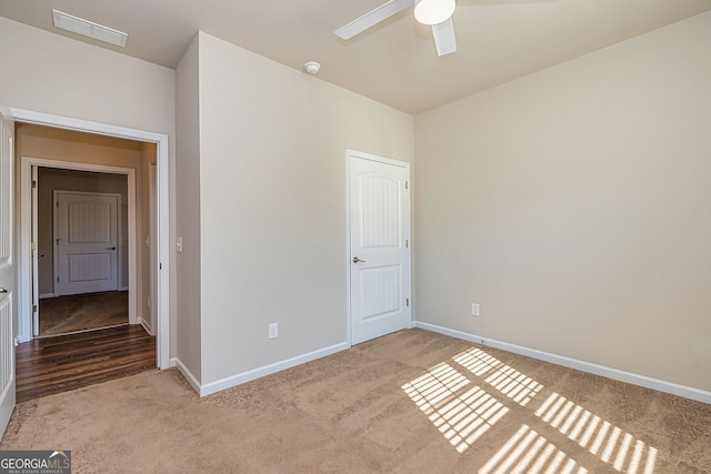 unfurnished bedroom featuring carpet flooring, baseboards, and visible vents