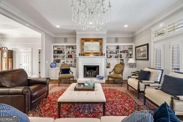 living area with a brick fireplace, wood finished floors, crown molding, and an inviting chandelier