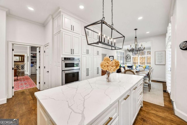 kitchen with white cabinets, ornamental molding, dark wood-style flooring, and stainless steel double oven