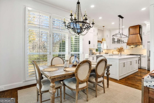 dining area with ornamental molding, wood finished floors, recessed lighting, baseboards, and a chandelier