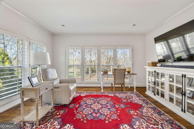 living area with crown molding and wood finished floors