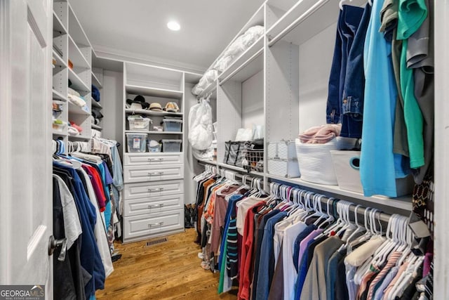 spacious closet featuring visible vents and wood finished floors