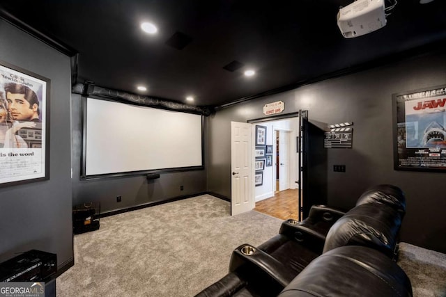 home theater room with carpet flooring, recessed lighting, crown molding, and baseboards