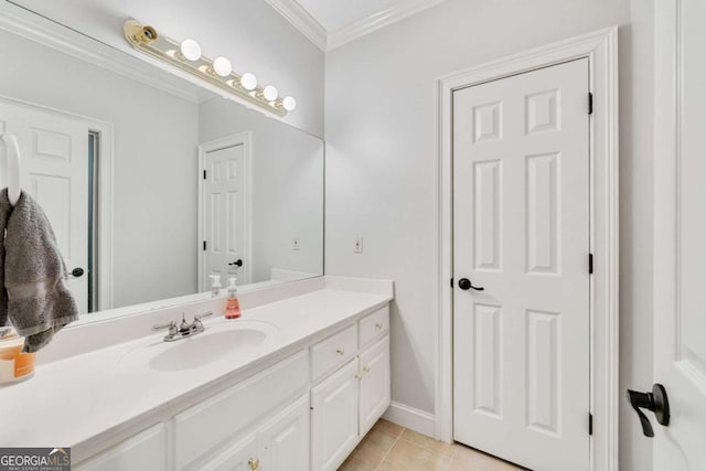 bathroom with tile patterned flooring, vanity, baseboards, and ornamental molding