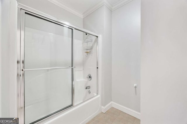 bathroom with tile patterned floors, baseboards, enclosed tub / shower combo, and crown molding