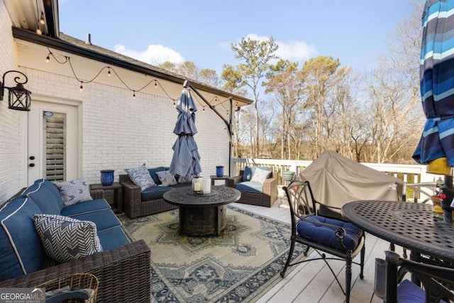 wooden terrace featuring an outdoor living space