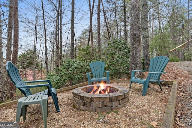 view of yard with an outdoor fire pit