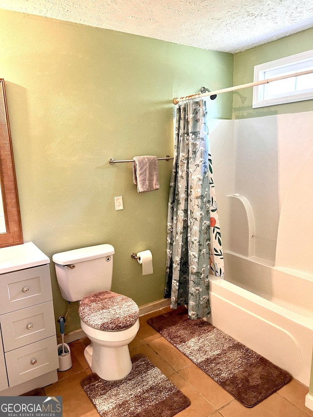 full bath with tile patterned floors, toilet, shower / bath combo, a textured ceiling, and baseboards