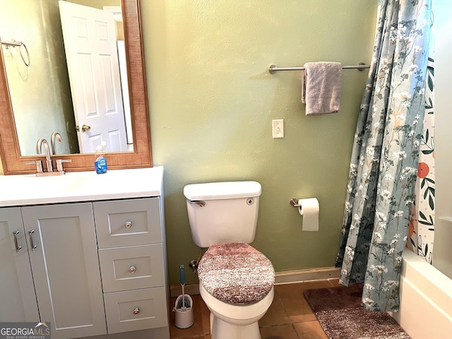 full bathroom featuring tile patterned flooring, toilet, vanity, and baseboards