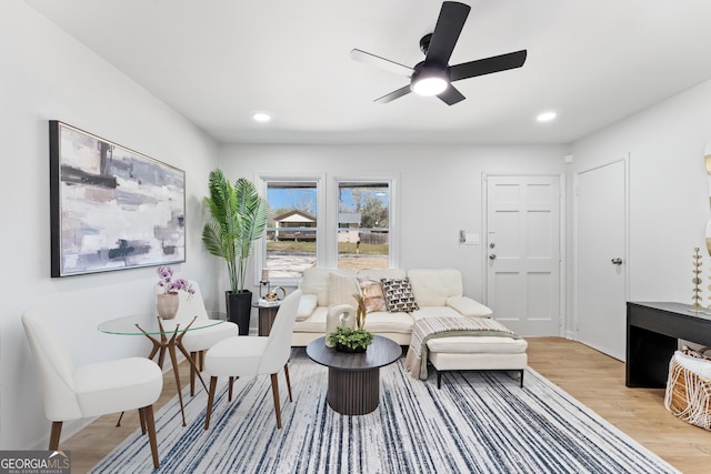 living area with a ceiling fan, light wood-style flooring, and recessed lighting