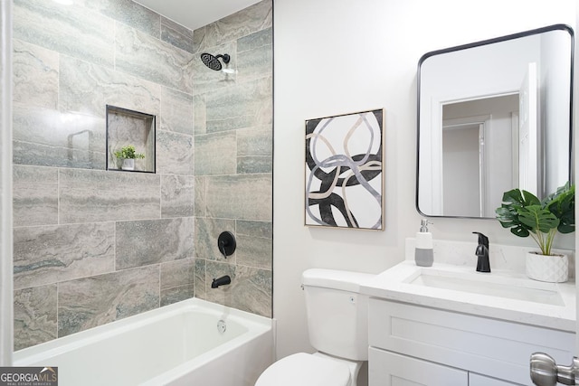 bathroom with toilet, vanity, and  shower combination