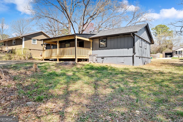 view of front of house featuring crawl space, roof with shingles, board and batten siding, and a front lawn