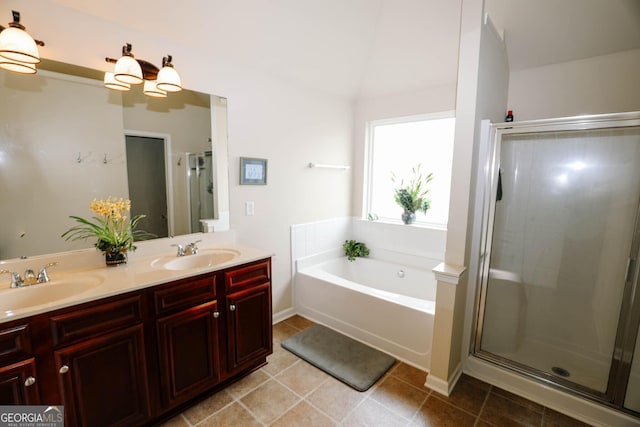 full bathroom featuring a sink, a garden tub, double vanity, and a shower stall