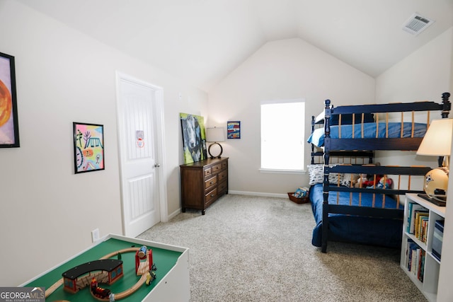 carpeted bedroom with lofted ceiling, baseboards, and visible vents