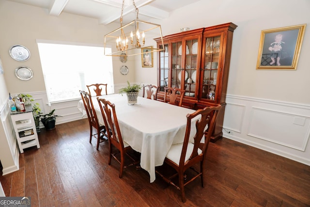 dining area featuring beamed ceiling, a notable chandelier, wainscoting, and dark wood-style flooring