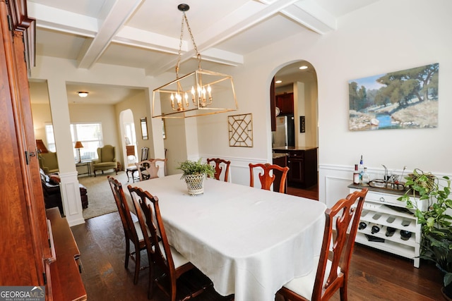 dining room featuring beam ceiling, arched walkways, dark wood-type flooring, and coffered ceiling