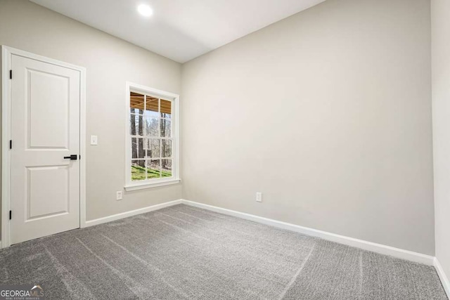 unfurnished room featuring baseboards and carpet floors