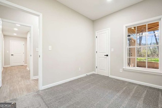 spare room with carpet flooring and baseboards