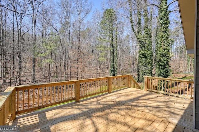 wooden deck featuring a view of trees