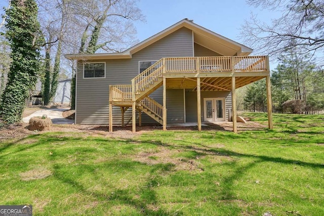 rear view of property with a yard, french doors, stairs, and a deck