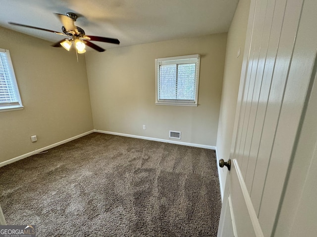 spare room with baseboards, visible vents, carpet floors, and ceiling fan