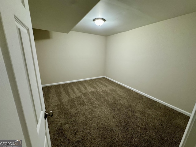 interior space with baseboards and carpet