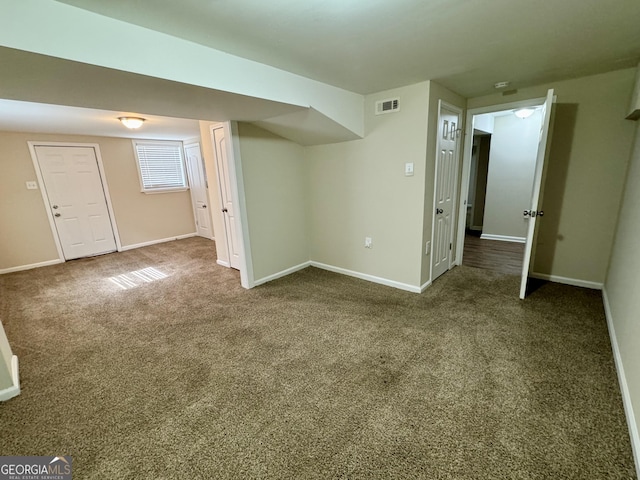 interior space with visible vents, carpet, and baseboards